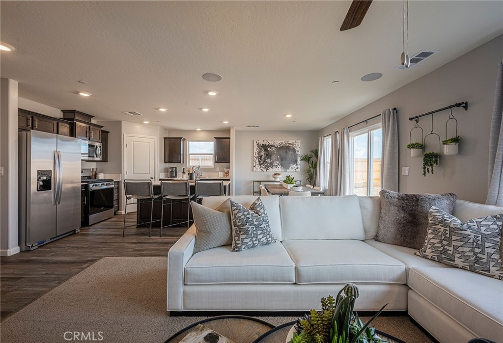 4735 Jema Way, Unit 9 B1 Merced, CA 95348 - Photo 8 of 19 a living room with furniture and kitchen view