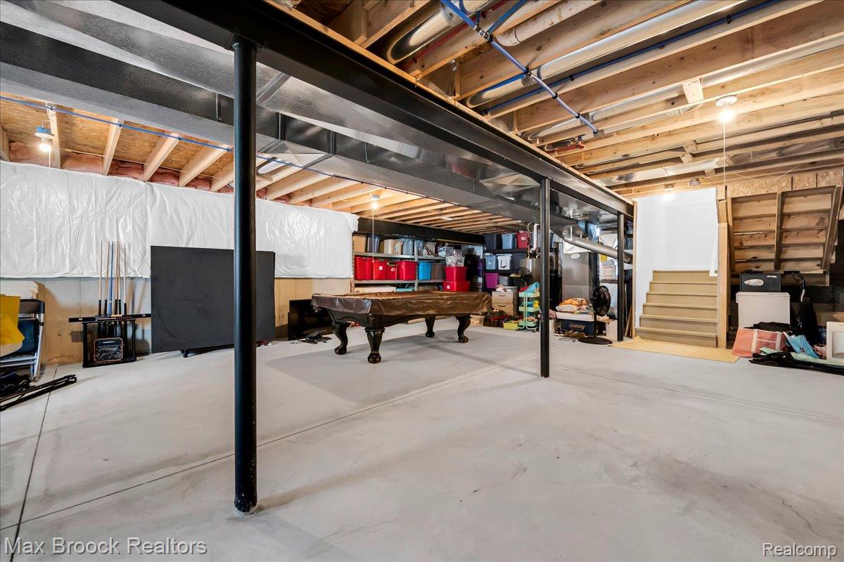 1126 Queensboro Drive Rochester, MI 48307 - Photo 26 of 66 Expansive unfinished basement featuring a concrete floor, exposed wooden ceiling joists, and structural steel beams