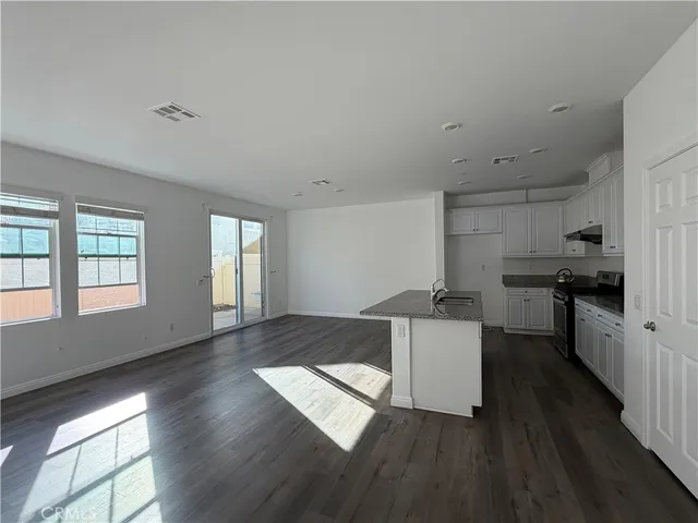 a kitchen with granite countertop a stove and a refrigerator