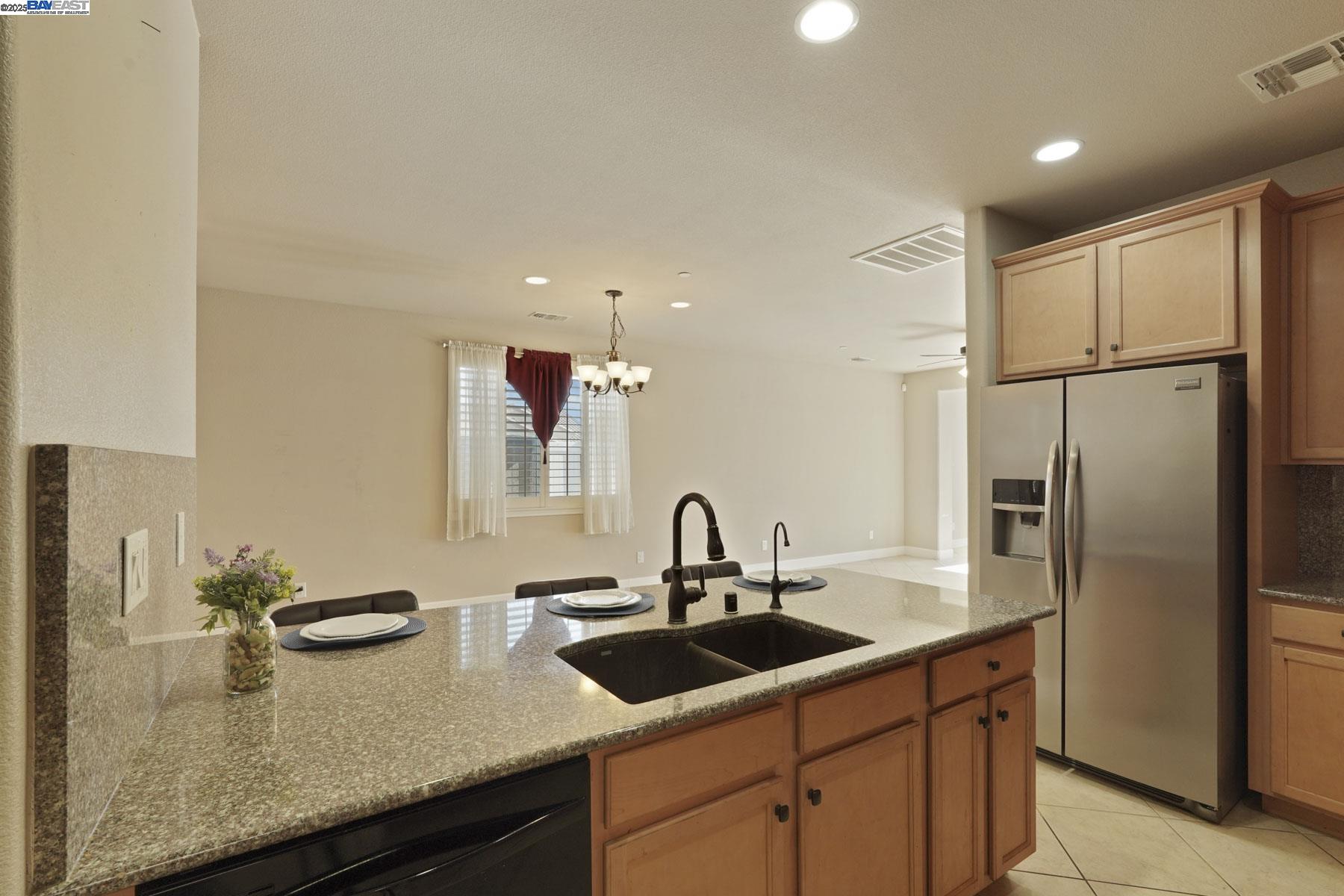 2961 Clear Pt Way Manteca, CA 95336 - Photo 12 of 54 a kitchen with granite countertop a sink and refrigerator