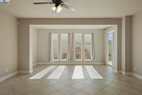 a living room with furniture and a ceiling fan