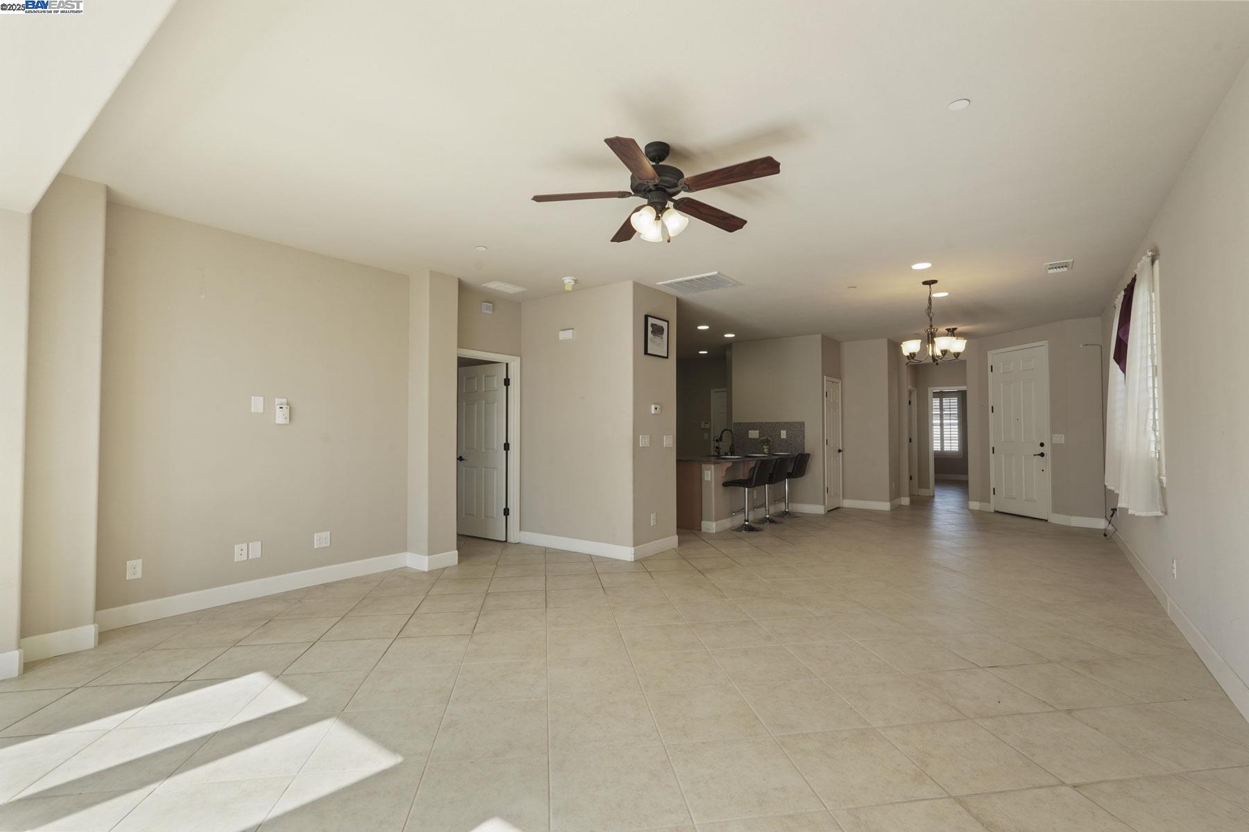 2961 Clear Pt Way Manteca, CA 95336 - Photo 24 of 54 a view of a livingroom with a ceiling fan and kitchen space