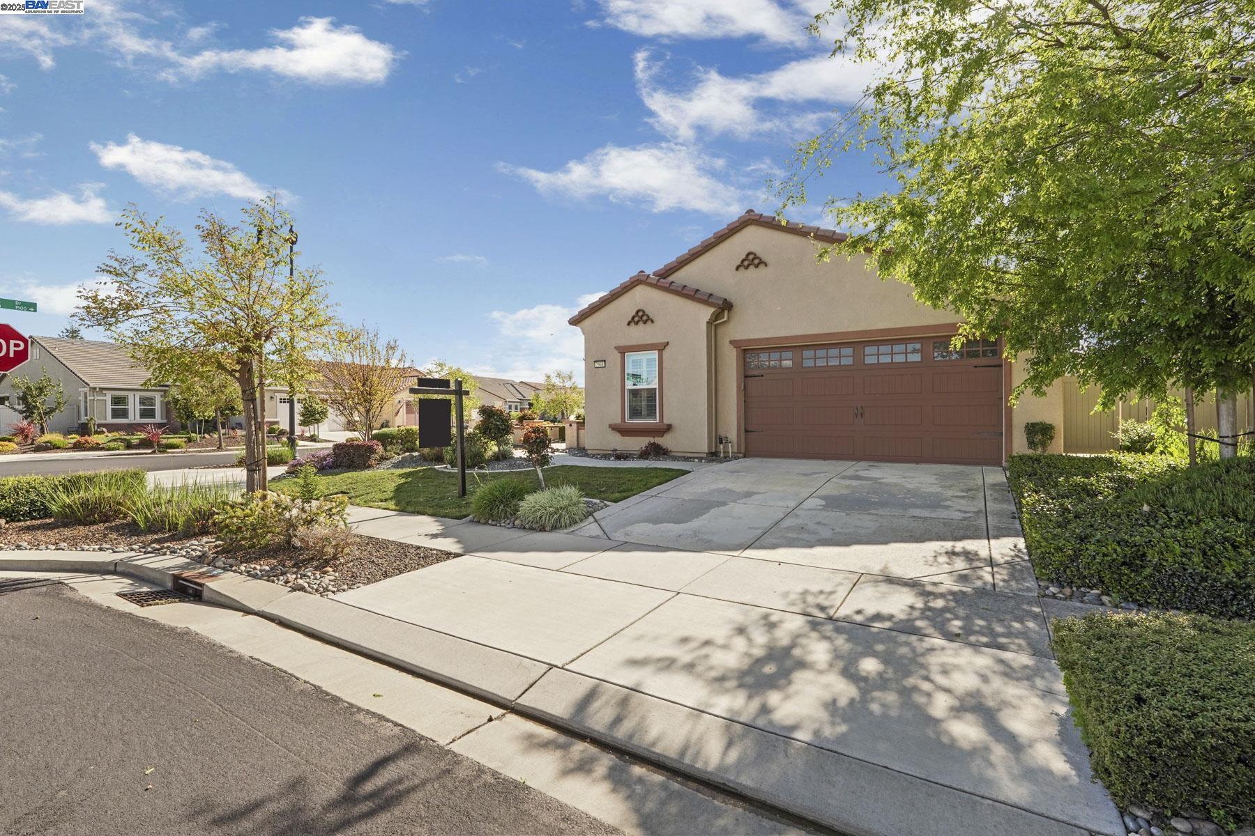 2961 Clear Pt Way Manteca, CA 95336 - Photo 3 of 54 a view of a white house with a street