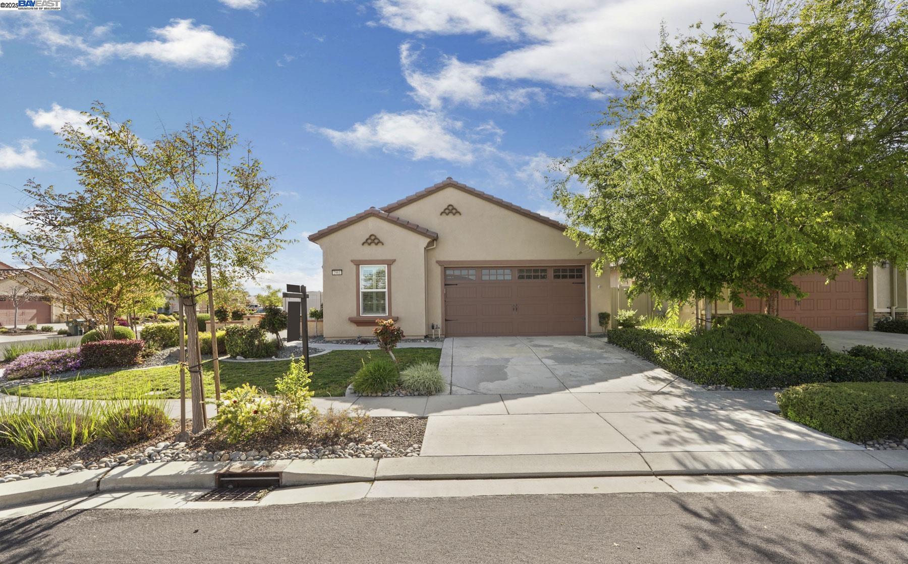 2961 Clear Pt Way Manteca, CA 95336 - Photo 4 of 54 a front view of a house with a yard and a garden
