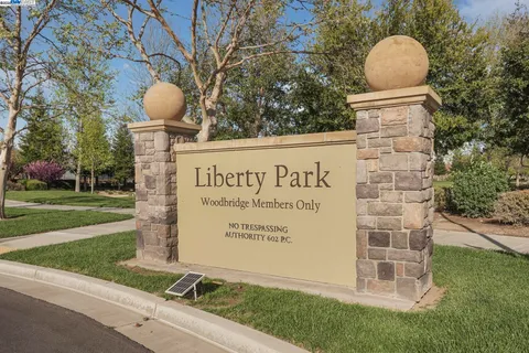 a view of a table and chairs under an umbrella in the patio