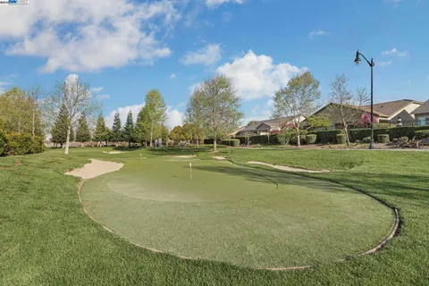 a view of a chair and tables in the patio of the house
