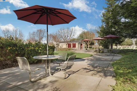 a view of a house with backyard sitting area and garden