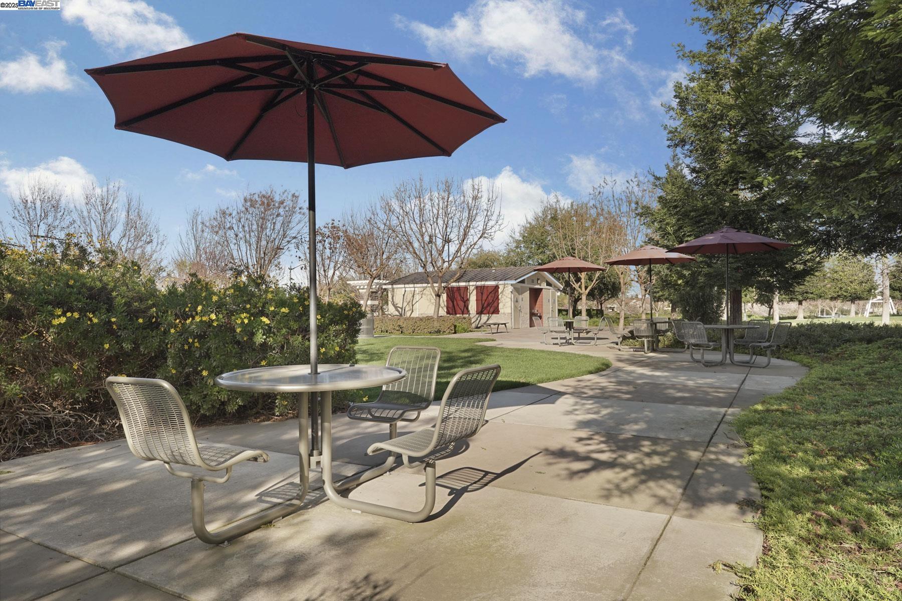 2961 Clear Pt Way Manteca, CA 95336 - Photo 49 of 54 a view of a table and chairs under an umbrella in the patio