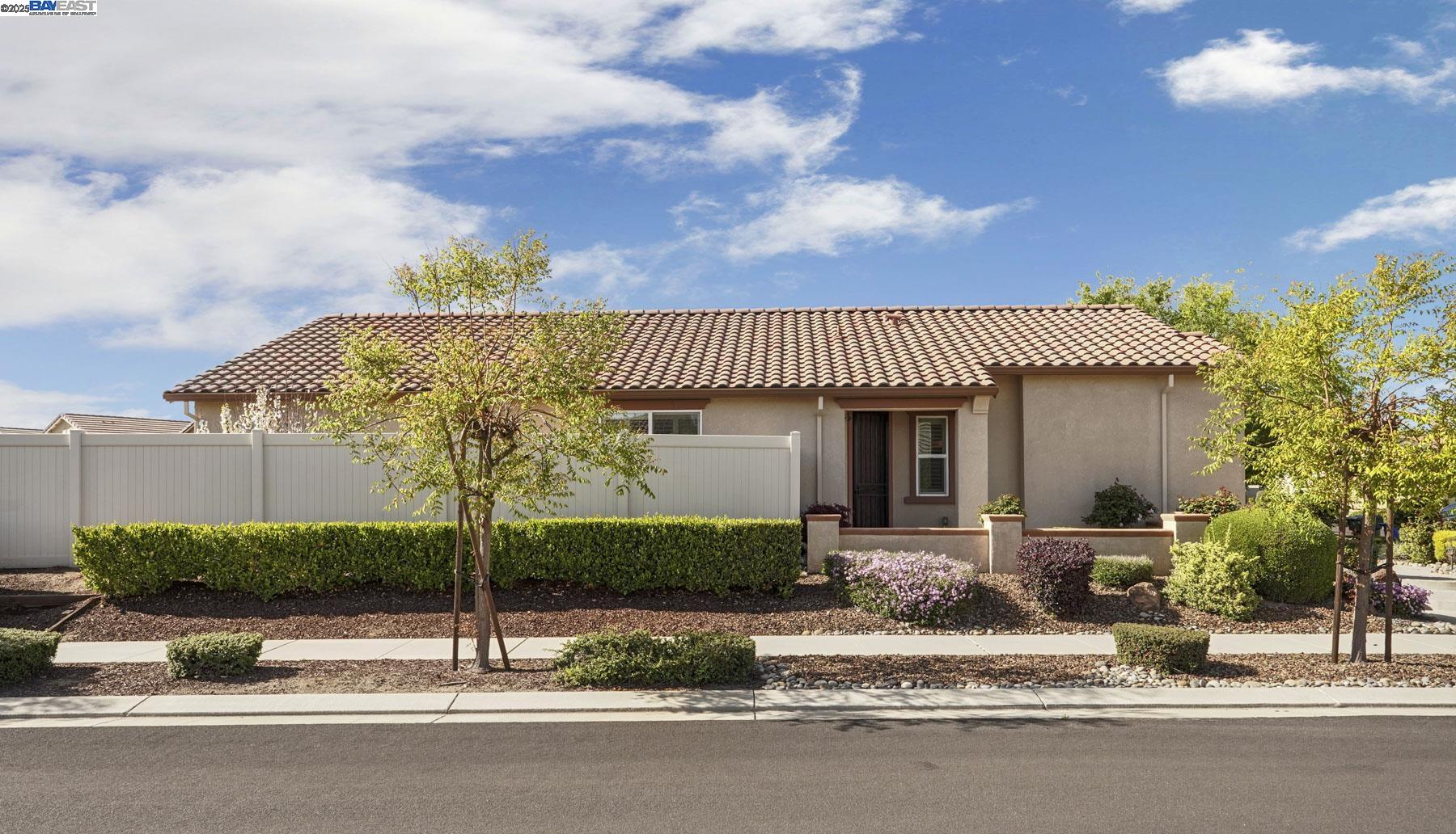 2961 Clear Pt Way Manteca, CA 95336 - Photo 6 of 54 a front view of a house with a garden