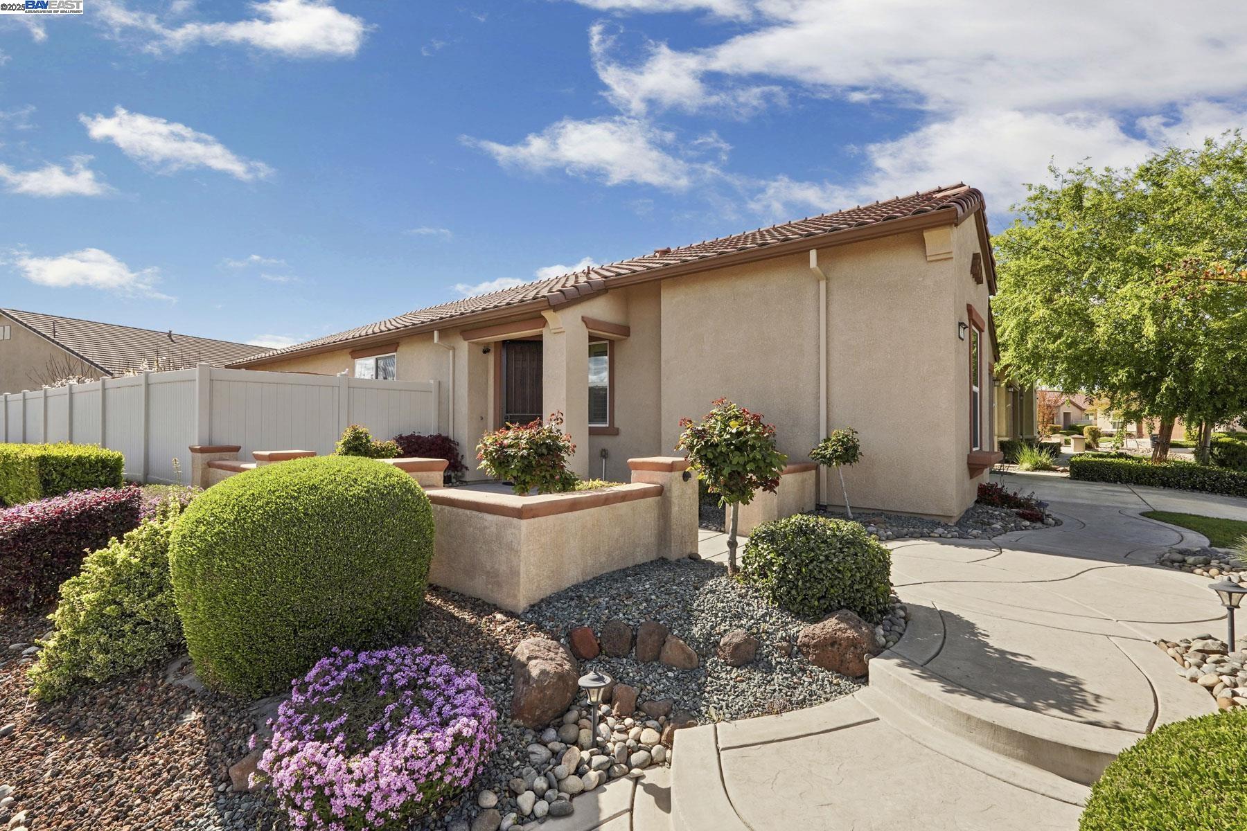 2961 Clear Pt Way Manteca, CA 95336 - Photo 7 of 54 a front view of a house with garden