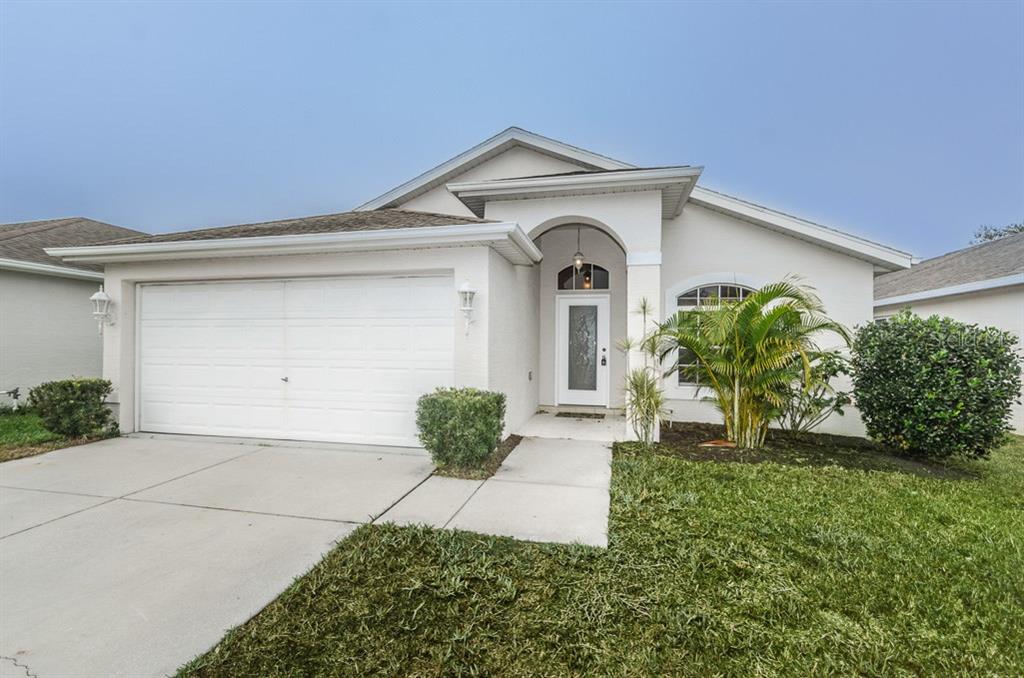 7652 Prospect Hill Circle New Port Richey, FL 34654 - Photo 1 of 1 a front view of a house with a yard
