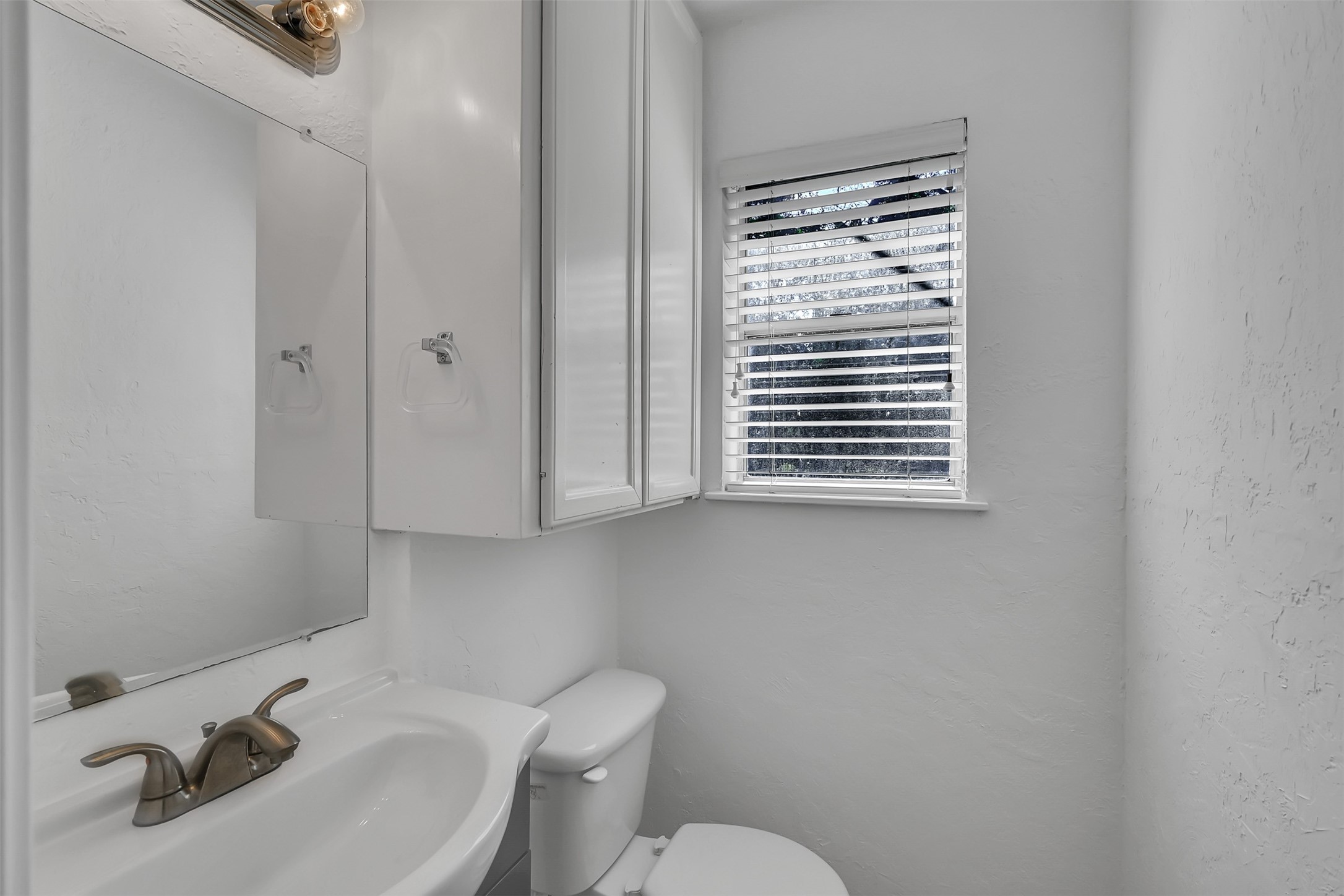 29806 Lazy Lane Spring, TX 77386 - Photo 11 of 22 a bathroom with a sink a toilet and a mirror