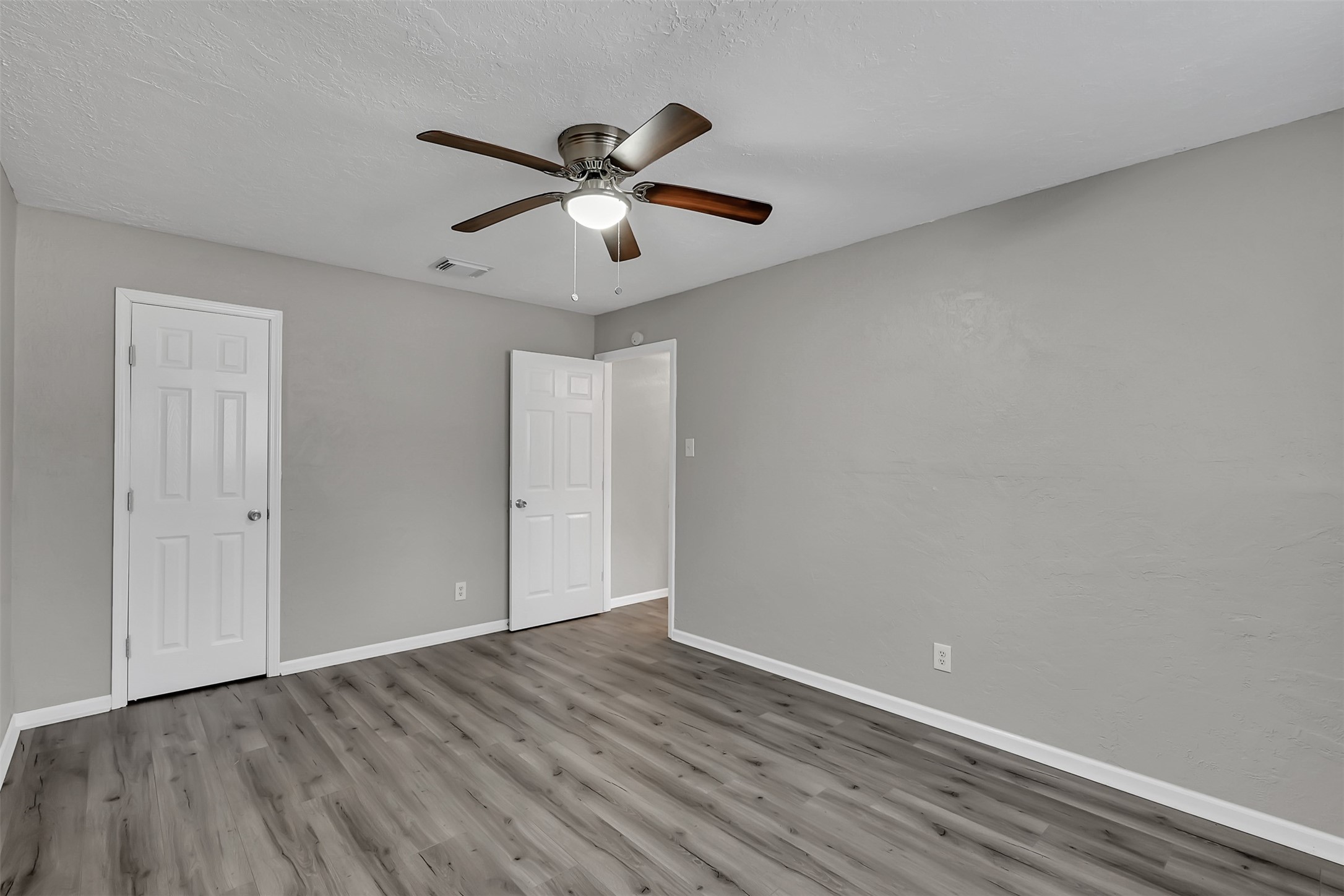 29806 Lazy Lane Spring, TX 77386 - Photo 13 of 22 an empty room with wooden floor fan and windows