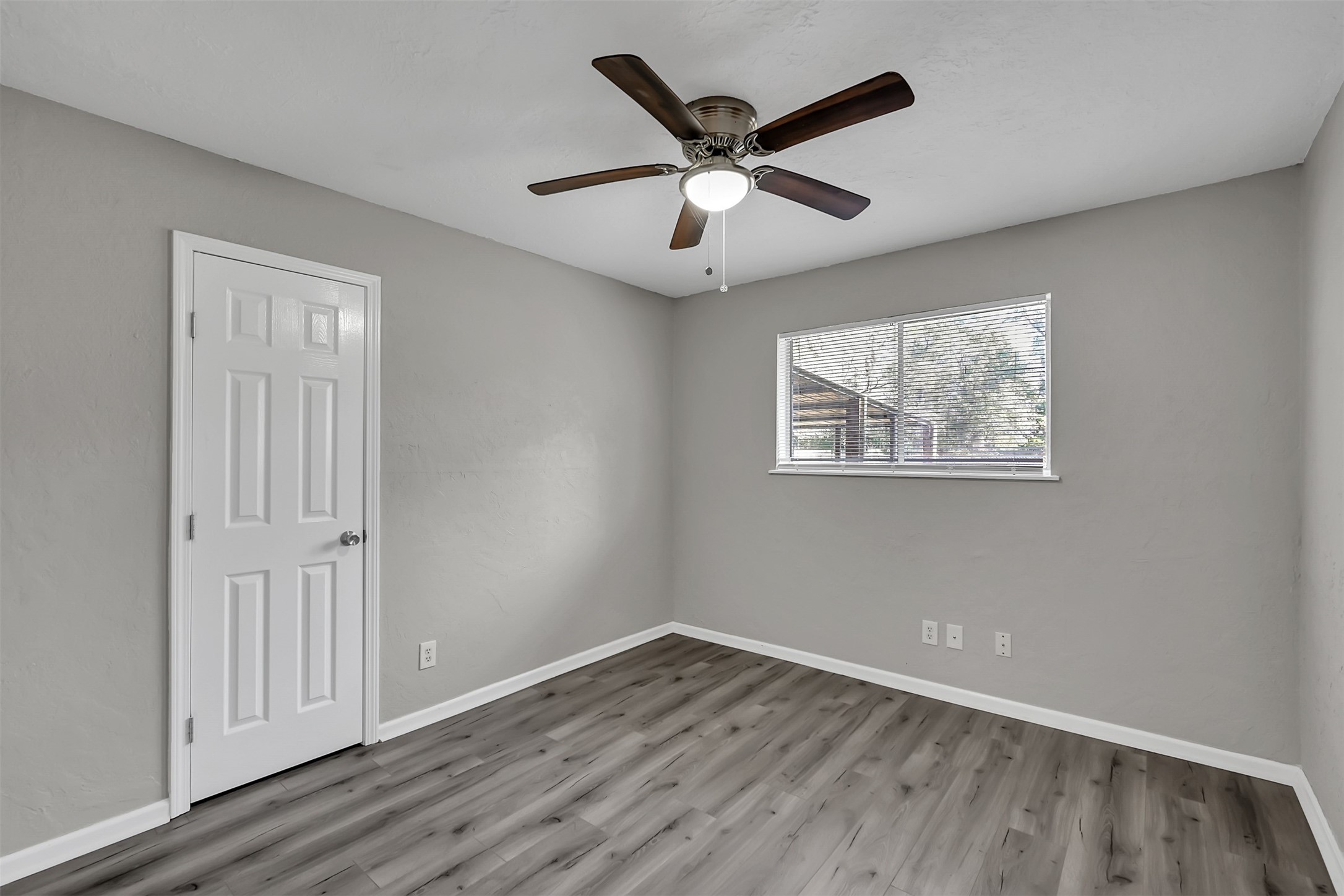 29806 Lazy Lane Spring, TX 77386 - Photo 15 of 22 an empty room with wooden floor ceiling fan and windows