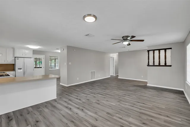 a view of empty room with wooden floor