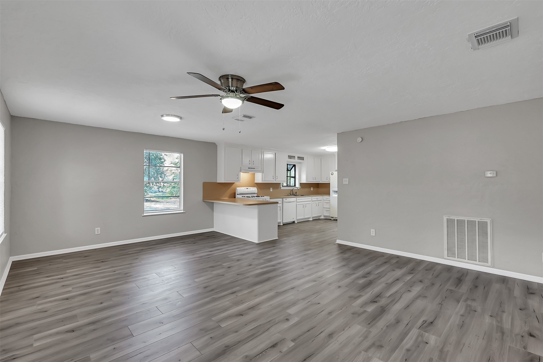 29806 Lazy Lane Spring, TX 77386 - Photo 8 of 22 a view of an empty room with a window and wooden floor