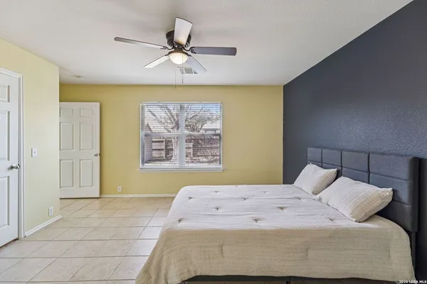 a bedroom with a bed and a painting on the wall