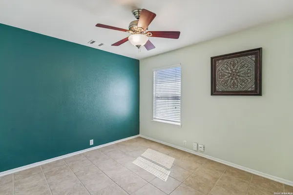 a view of a room with wooden floor and a window