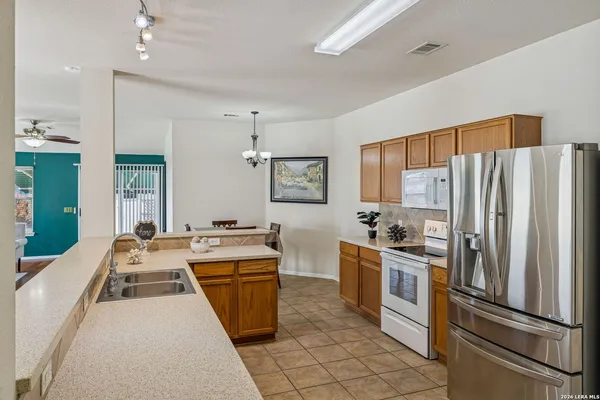 a kitchen with granite countertop stainless steel appliances counter space and a refrigerator