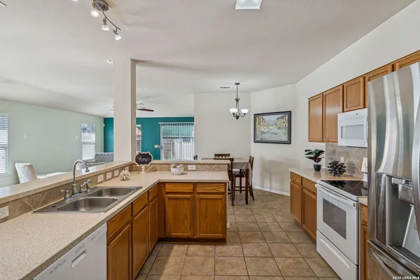 a kitchen with a sink stove and cabinets