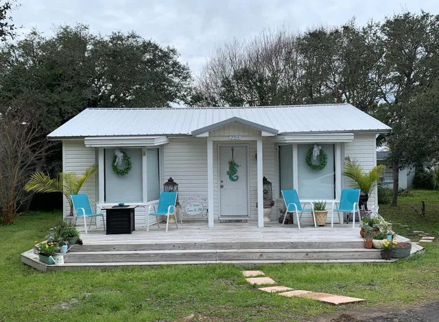 a front view of a house with a yard table and chairs