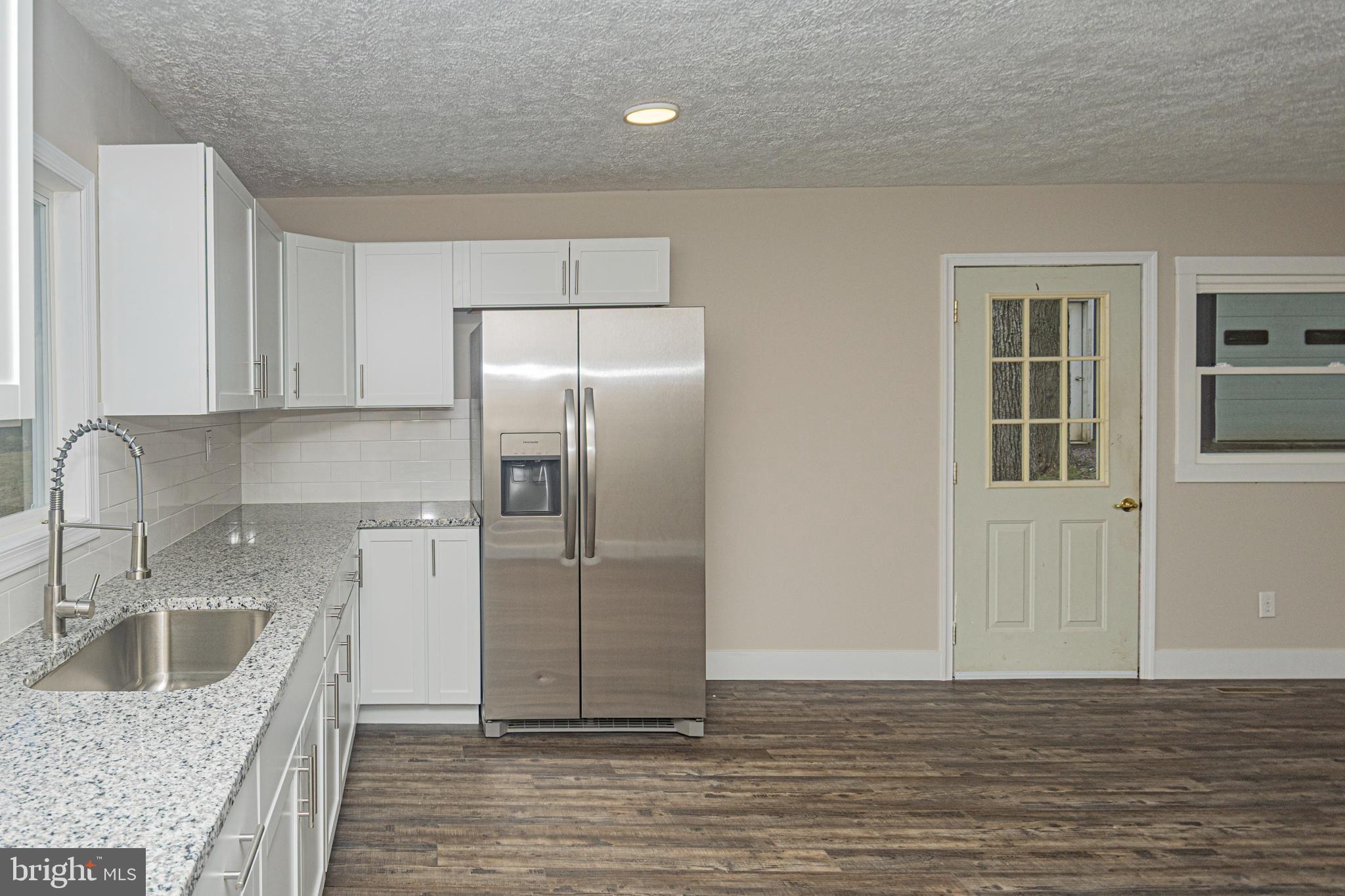 4376 Chestnut Ridge Road Grantsville, MD 21536 - Photo 7 of 51 a kitchen with stainless steel appliances granite countertop a refrigerator a sink and a stove