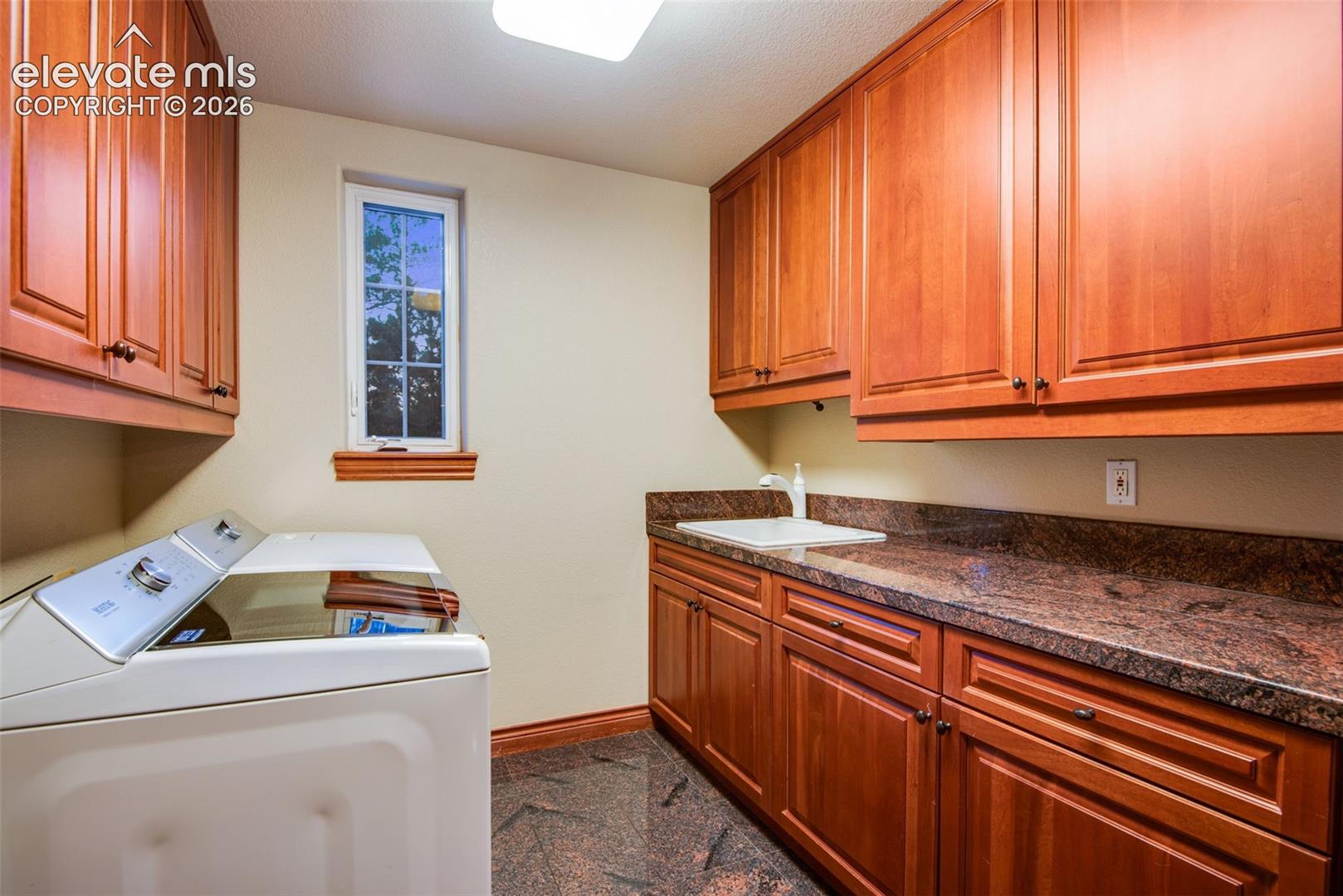 16075 Winding Trail Road Colorado Springs, CO 80908 - Photo 27 of 49 Laundry room located on the main level right off of the garage