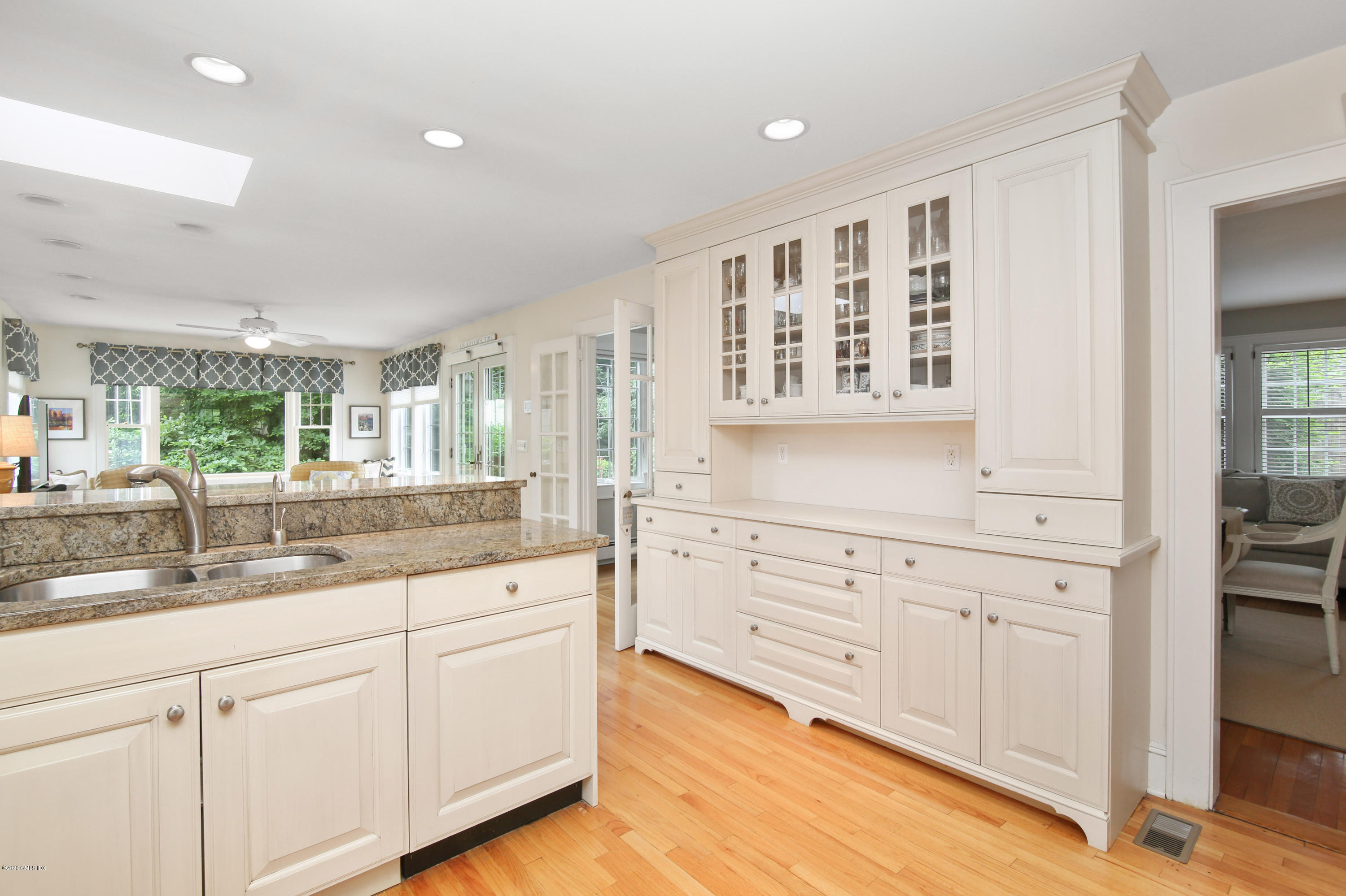 38 Oval Avenue Riverside, CT 06878 - Photo 11 of 33 a large white kitchen with granite countertop white cabinets and a large window