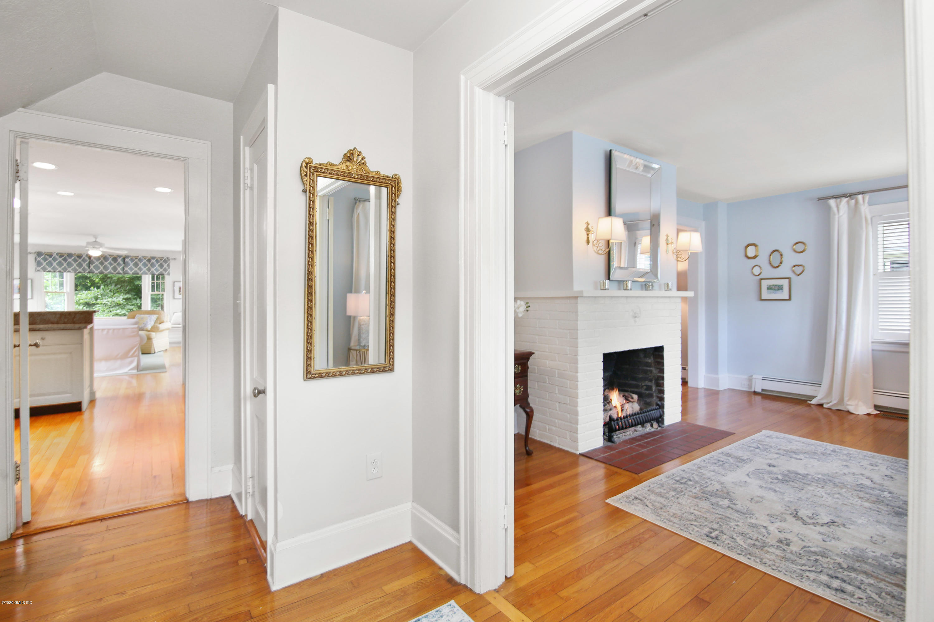 38 Oval Avenue Riverside, CT 06878 - Photo 5 of 33 a view of a livingroom with wooden floor and a fireplace