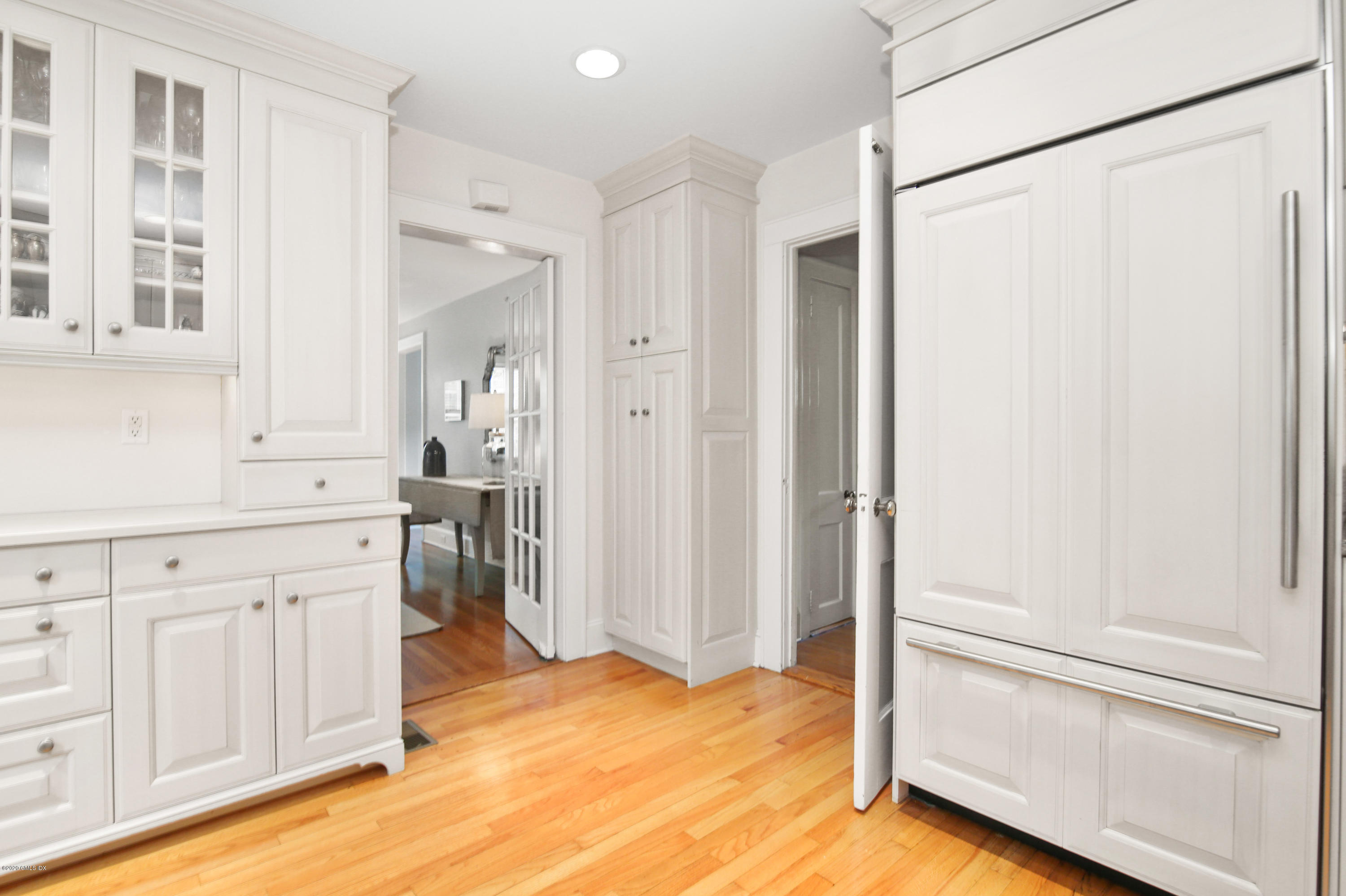 38 Oval Avenue Riverside, CT 06878 - Photo 10 of 33 a view of a kitchen with white cabinets and wooden floor