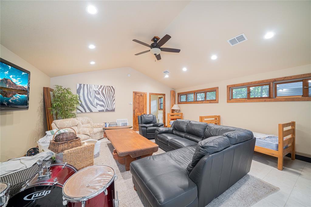 582 Windy Point Mount Vernon, TX 75457 - Photo 37 of 38 Living room with lofted ceiling, a ceiling fan, recessed lighting, and light tile patterned flooring