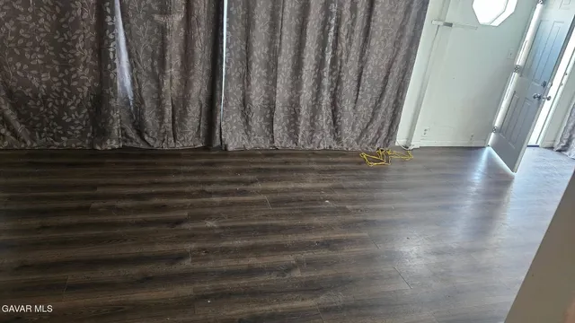 a view of a door with wooden floor