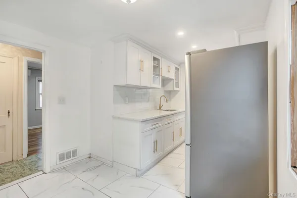 a kitchen with stainless steel appliances a refrigerator sink and microwave