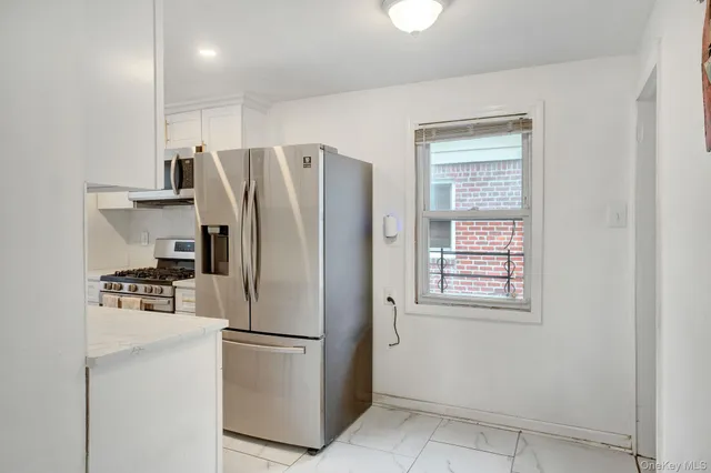 a kitchen with a sink and a refrigerator