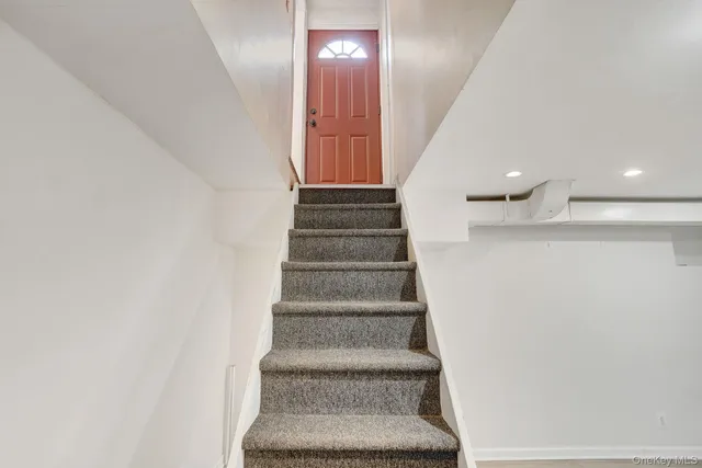 a view of a porch with a table and chairs