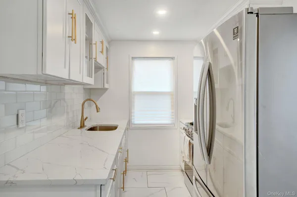 a kitchen with stainless steel appliances a refrigerator sink and stove