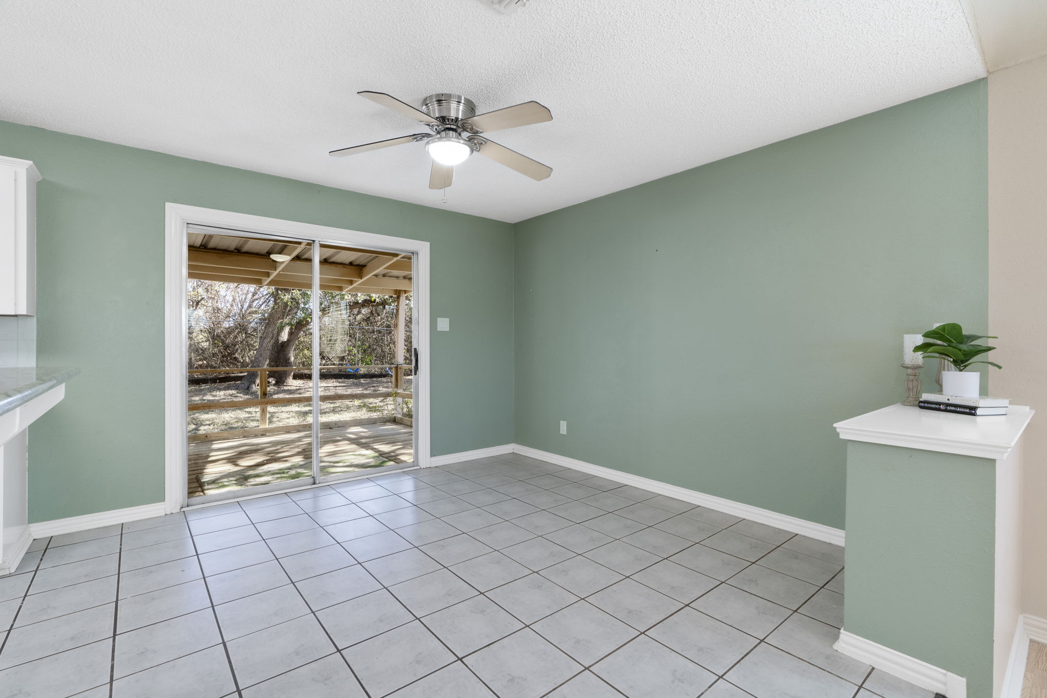500 Grand Prairie Circle Dripping Springs, TX 78620 - Photo 11 of 40 Empty room with light tile ceramic flooring, ceiling fan, and a textured ceiling