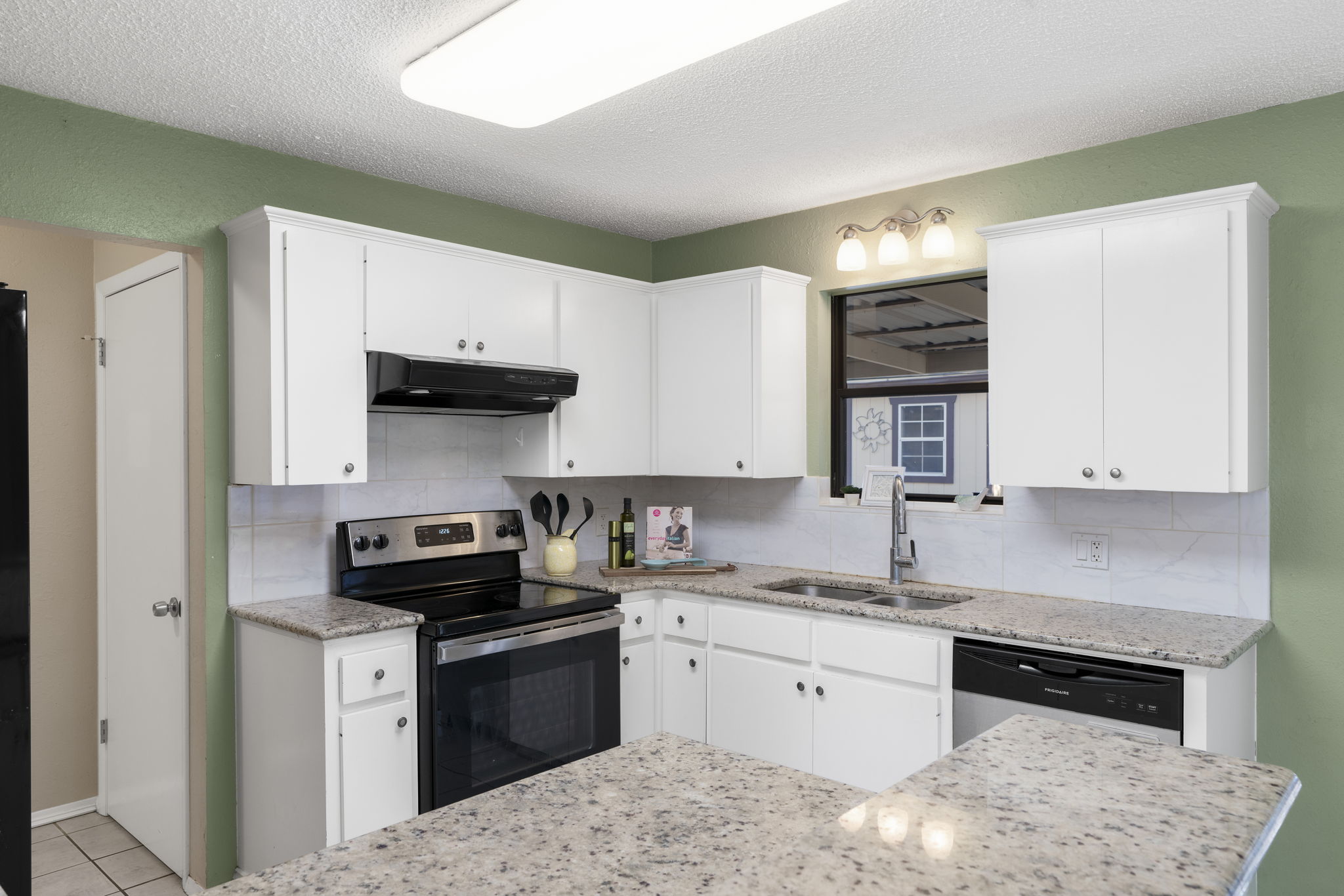 500 Grand Prairie Circle Dripping Springs, TX 78620 - Photo 15 of 40 a kitchen with stainless steel appliances granite countertop a sink stove and cabinets