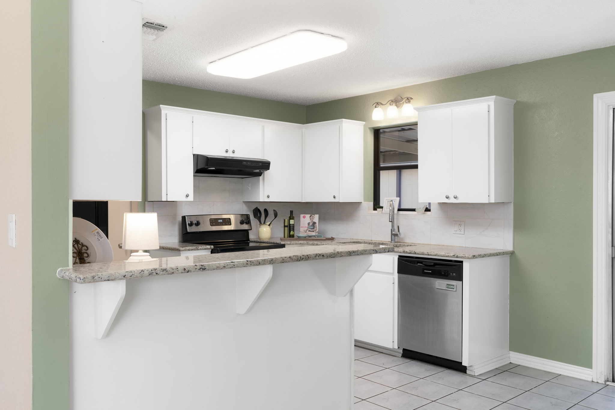 500 Grand Prairie Circle Dripping Springs, TX 78620 - Photo 24 of 40 a kitchen with stainless steel appliances granite countertop a sink stove and cabinets