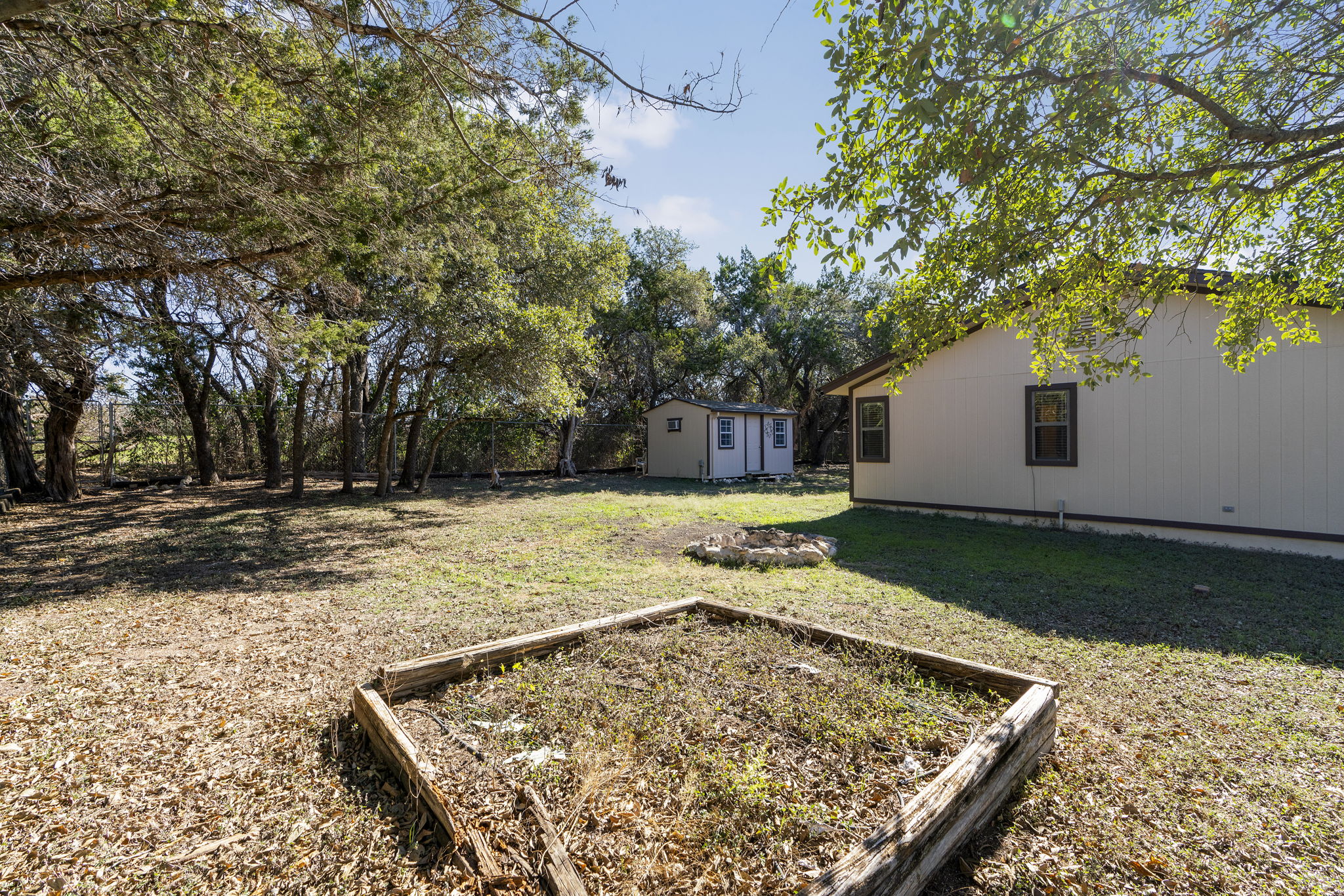 500 Grand Prairie Circle Dripping Springs, TX 78620 - Photo 27 of 40 a view of a backyard with large trees