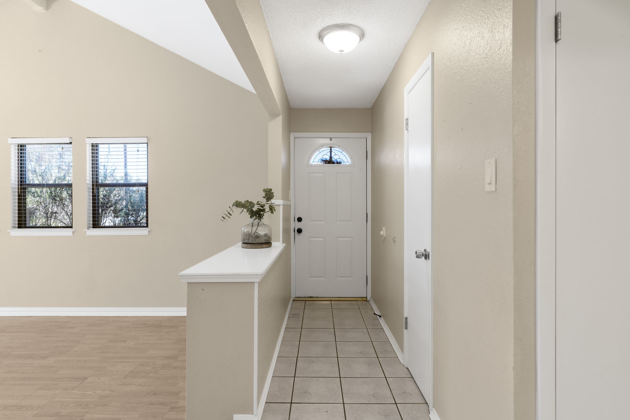 500 Grand Prairie Circle Dripping Springs, TX 78620 - Photo 5 of 40 Doorway to outside featuring wood laminate finished floors and lofted ceiling