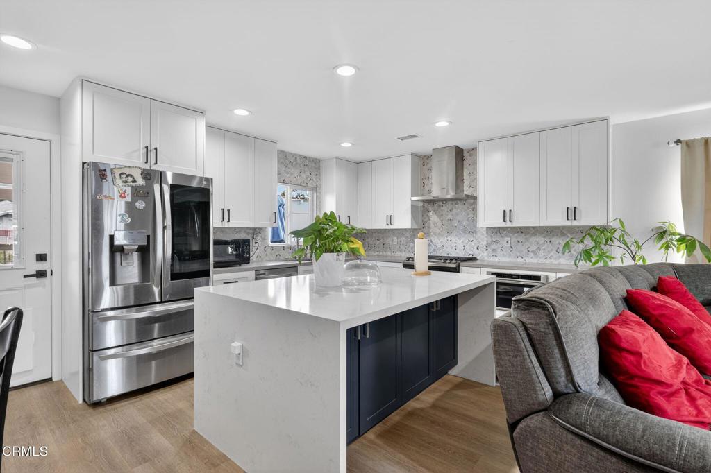 2377 Fitzgerald Road Simi Valley, CA 93065 - Photo 11 of 30 a kitchen with granite countertop a refrigerator and a stove top oven
