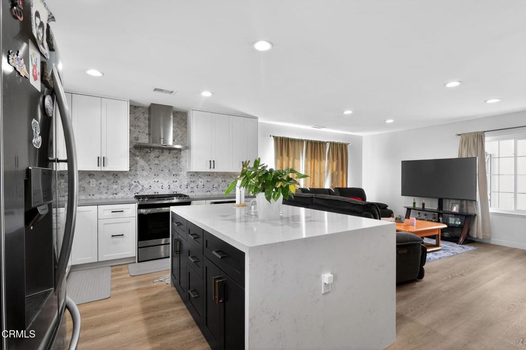 2377 Fitzgerald Road Simi Valley, CA 93065 - Photo 14 of 30 a kitchen with kitchen island granite countertop a sink a counter top space appliances and cabinets