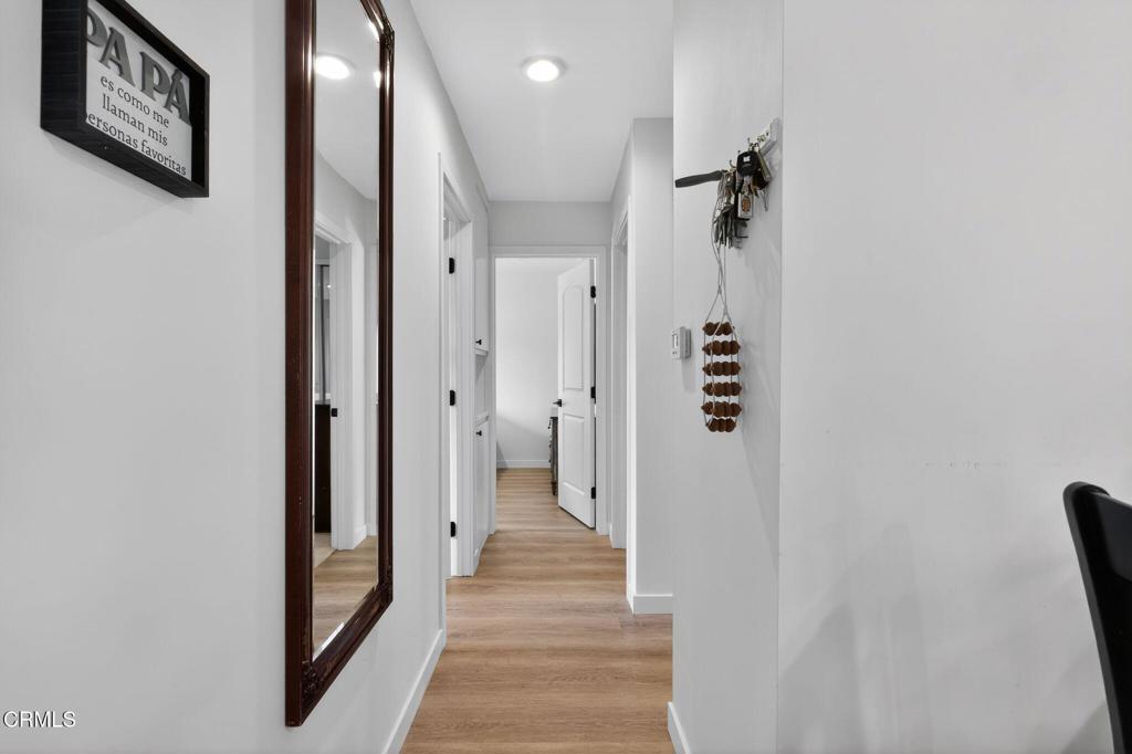 2377 Fitzgerald Road Simi Valley, CA 93065 - Photo 16 of 30 a view of a hallway with wooden floor and staircase