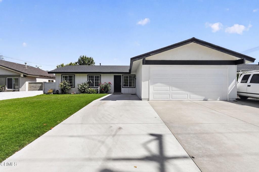 2377 Fitzgerald Road Simi Valley, CA 93065 - Photo 2 of 30 a front view of a house with a yard and garage
