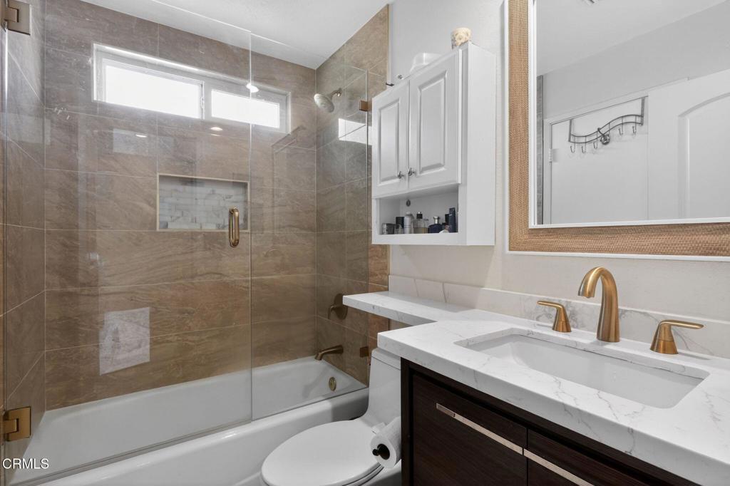 2377 Fitzgerald Road Simi Valley, CA 93065 - Photo 25 of 30 a bathroom with a granite countertop sink toilet and shower