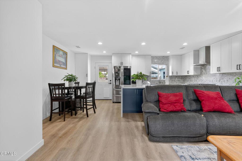 2377 Fitzgerald Road Simi Valley, CA 93065 - Photo 6 of 30 a kitchen with stainless steel appliances granite countertop a stove top oven a sink dishwasher a dining table and chairs with wooden floor