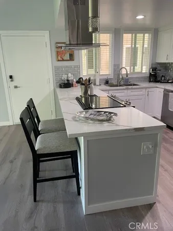 a kitchen with a sink appliances and cabinets