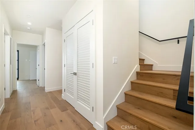 a view of entryway with wooden floor and stairs
