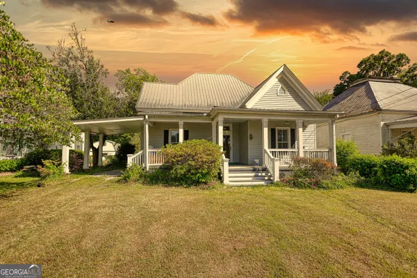 a front view of a house with a garden